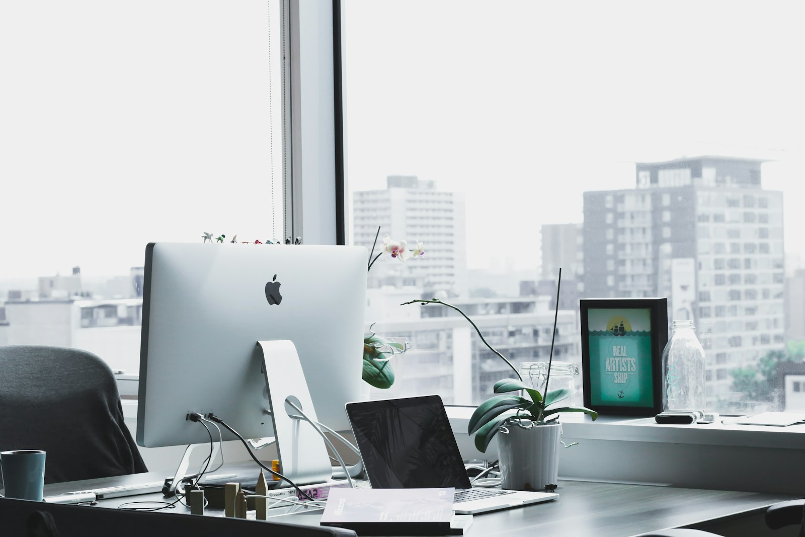 Bright office desk with a computer ready for client meetings
