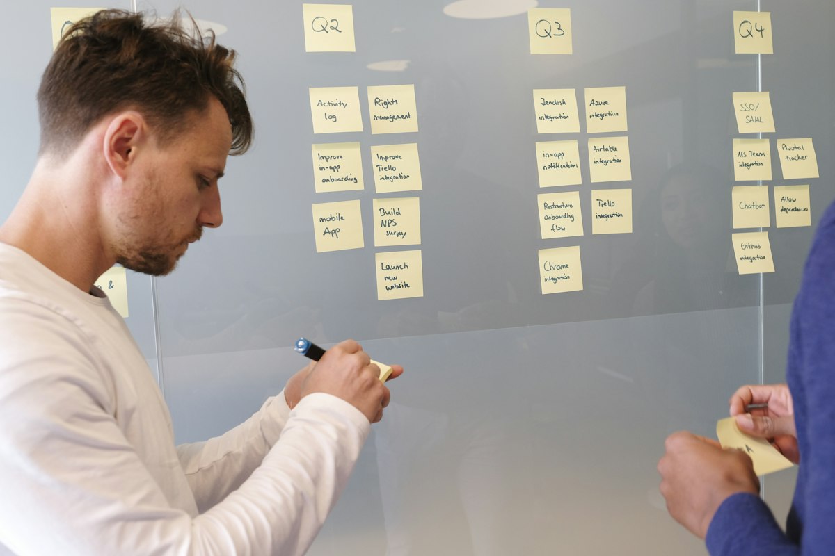 Facilitator writing on a whiteboard during a planning session