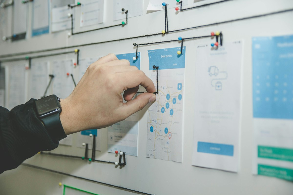 Hand placing a card on a project roadmap board