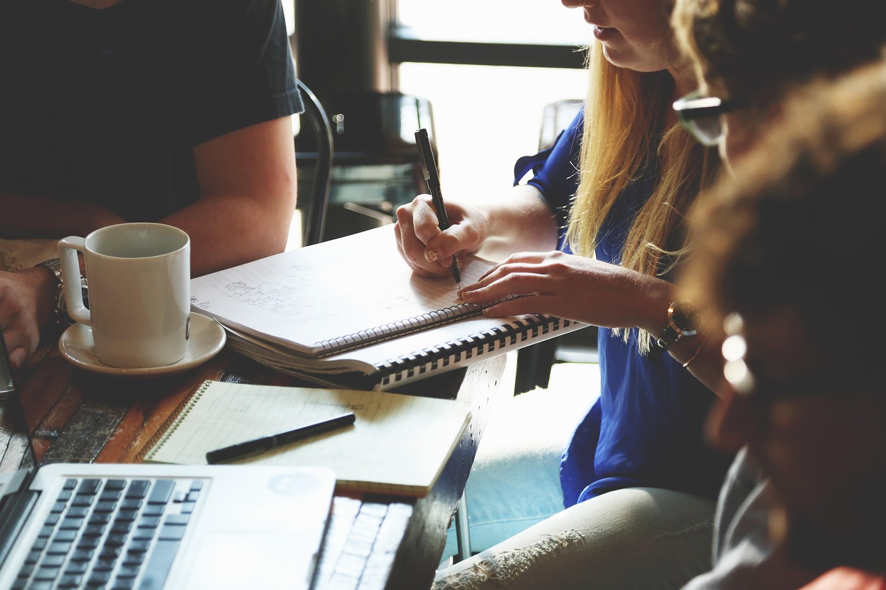 Small business consulting session with laptops and notebooks on a table